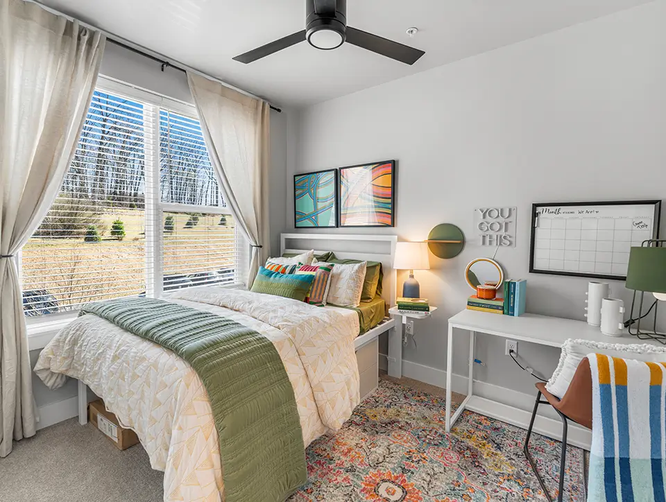 furnished bedroom with a view of an open green space