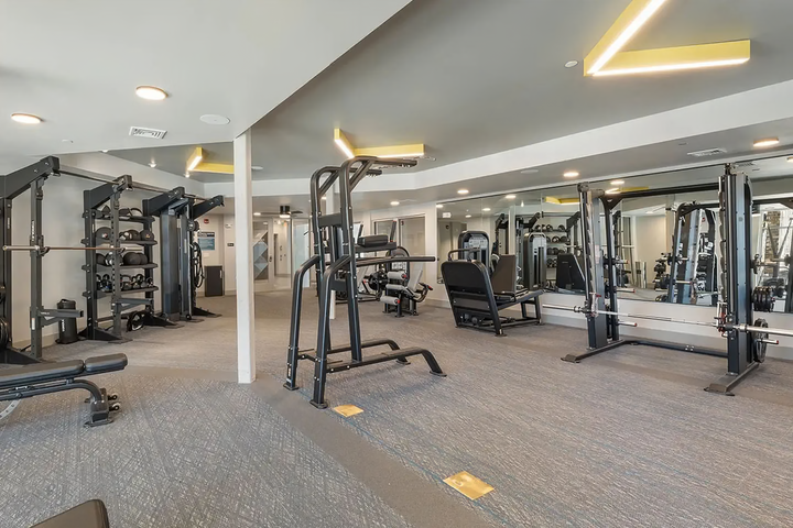 Gym area with various types of fitness equipment.
